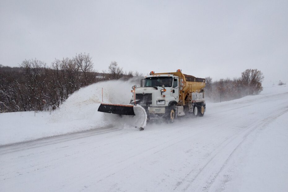A photograph of a snowplow plowing snow.