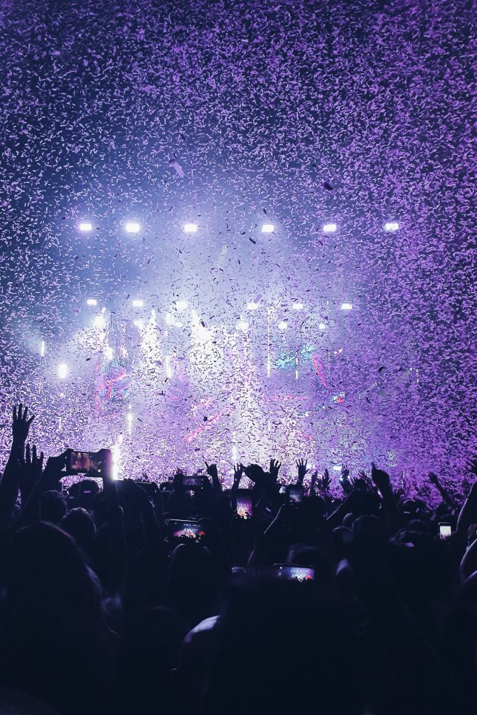 People at a concert with confetti.