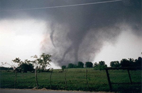 Photo of the Jarrell tornado which was immortalized in one of the most iconic pieces of tornado photography, famously dubbed "Dead Man Walking." Captured by Scott Beckwith, the photograph gained notoriety for its eerie resemblance to the grim reaper. (Photo courtesy of NOAA and Scott Beckwith, Jarrell Farm Supply, Jarrell, TX)