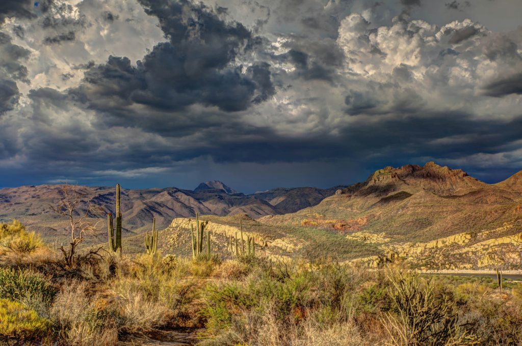 A photograph of monsoon rain storms building over a desert landscape in Arizona, US.