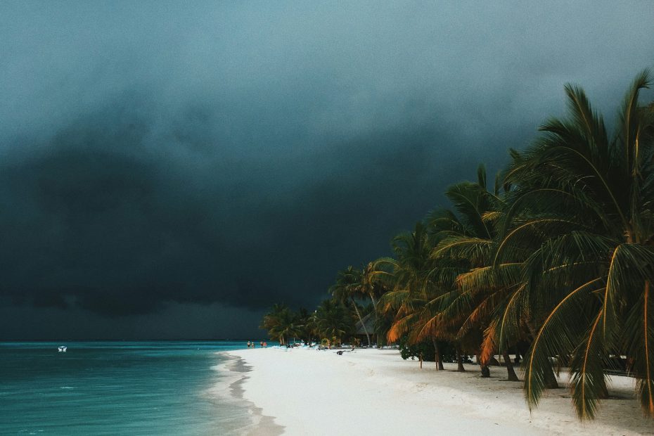 Dark storm coming towards a tropical beach - photo by Ibrahim Rifath via Unsplash