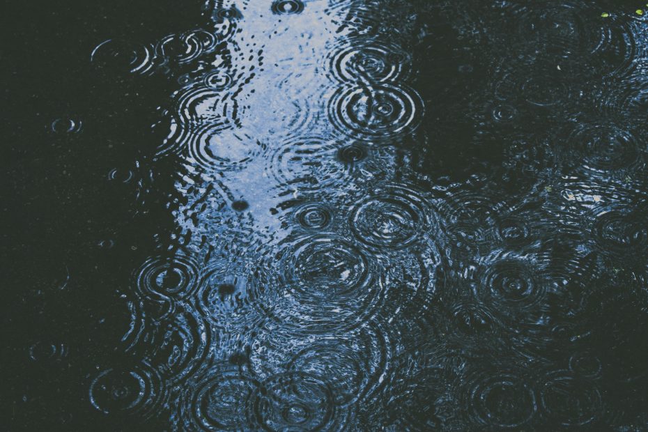 Rain falling in the street creating a puddle - photo by Alex Dukhanov via Unsplash