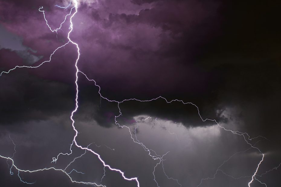 Purple lightning in the sky at night. Photo by David Moum via Unsplash